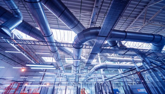 Air conditioning of buildings. Background of ventilation pipes. Laying of engineering networks. Industrial background